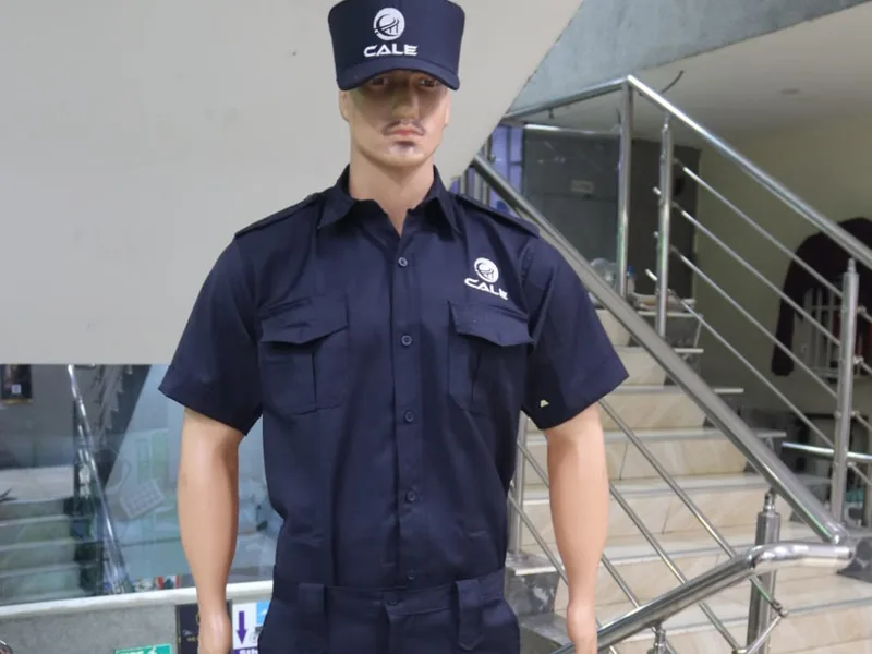 Navy security uniform shirt, trousers and cap with a company logo embroidered on the cap and pocket